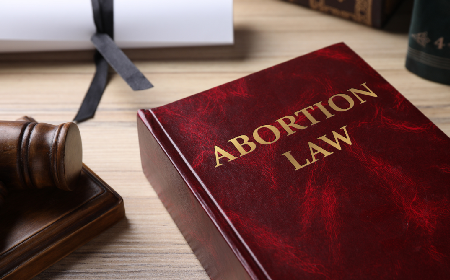 Book about abortion laws laying on a wood desk